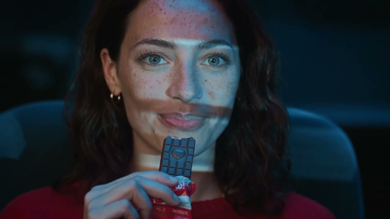 TAKE 02 still — a face lit by the screen